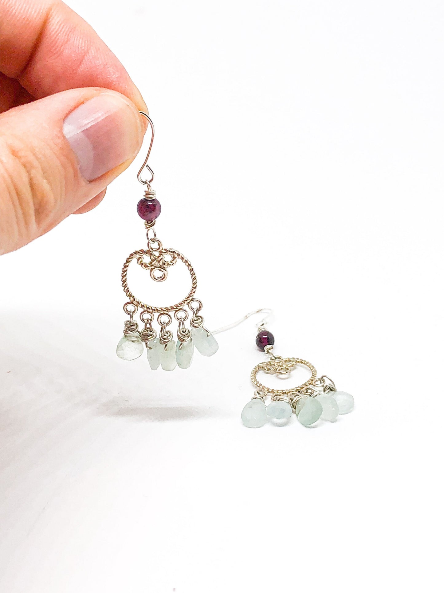 Silver filigree earrings with aquamarine teardrops and garnet accent