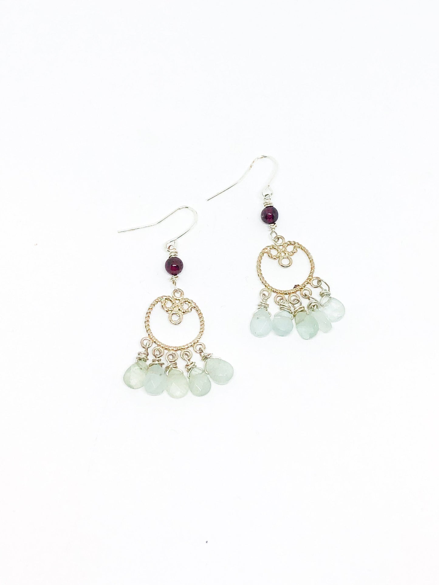 Silver filigree earrings with aquamarine teardrops and garnet accent