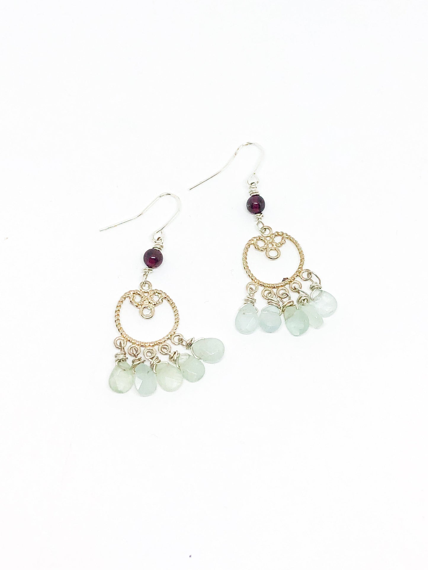 Silver filigree earrings with aquamarine teardrops and garnet accent