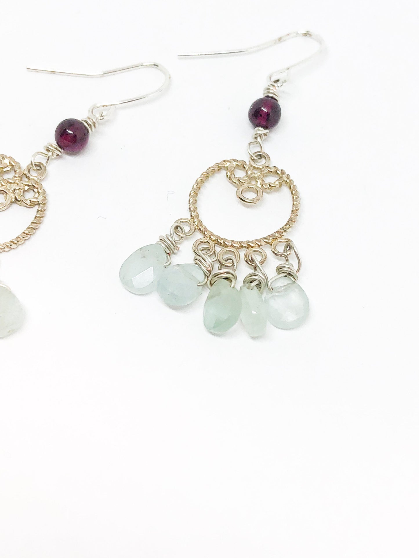 Silver filigree earrings with aquamarine teardrops and garnet accent