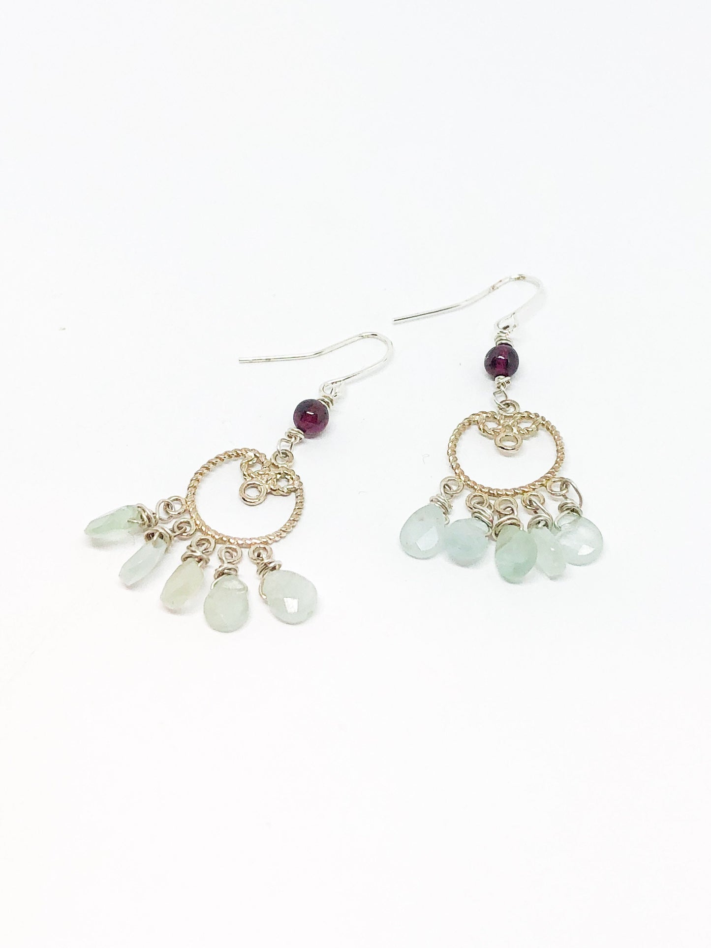 Silver filigree earrings with aquamarine teardrops and garnet accent