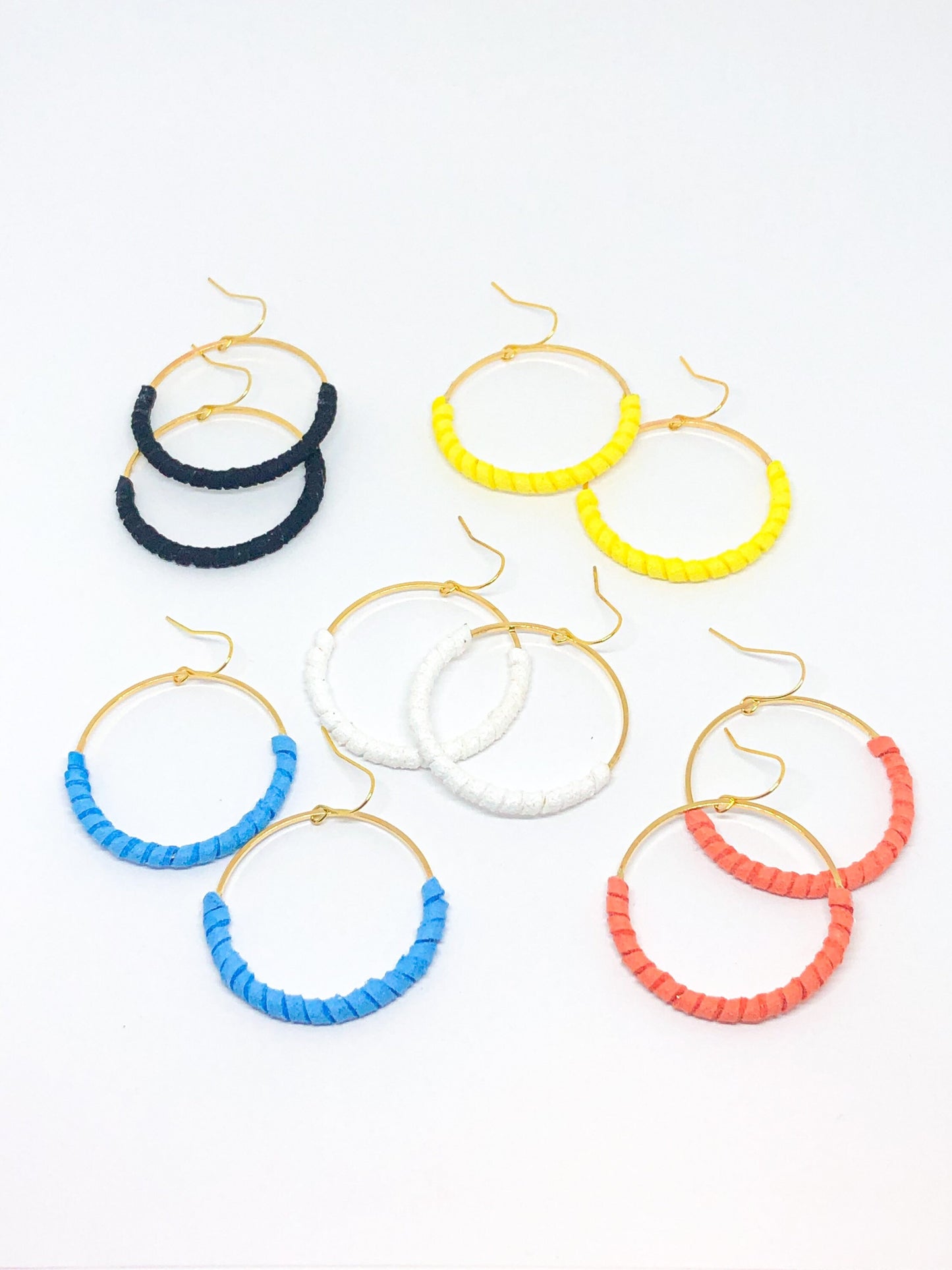 Gold hoop earrings with coral faux suede