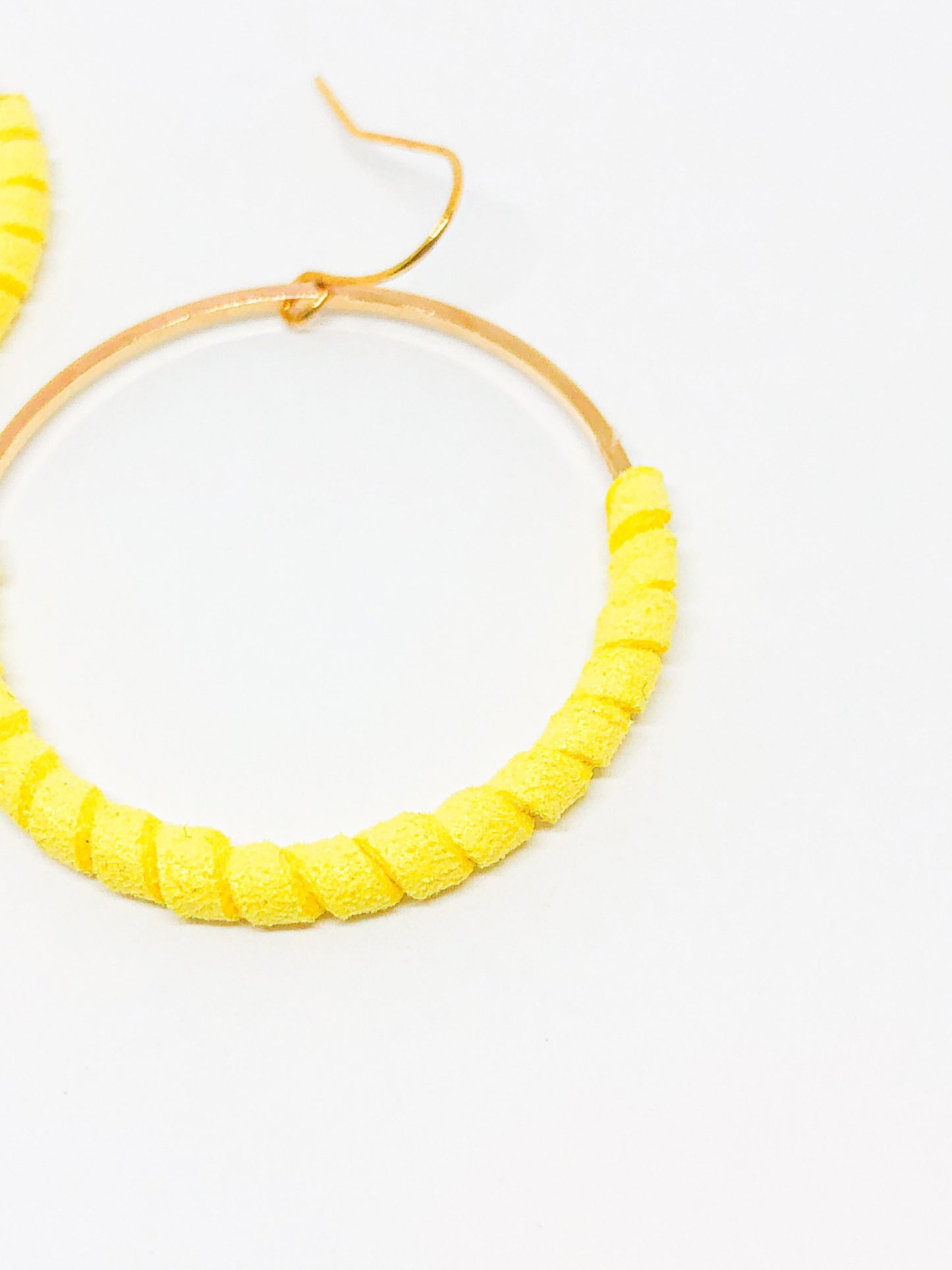 Gold hoop earrings with yellow faux suede