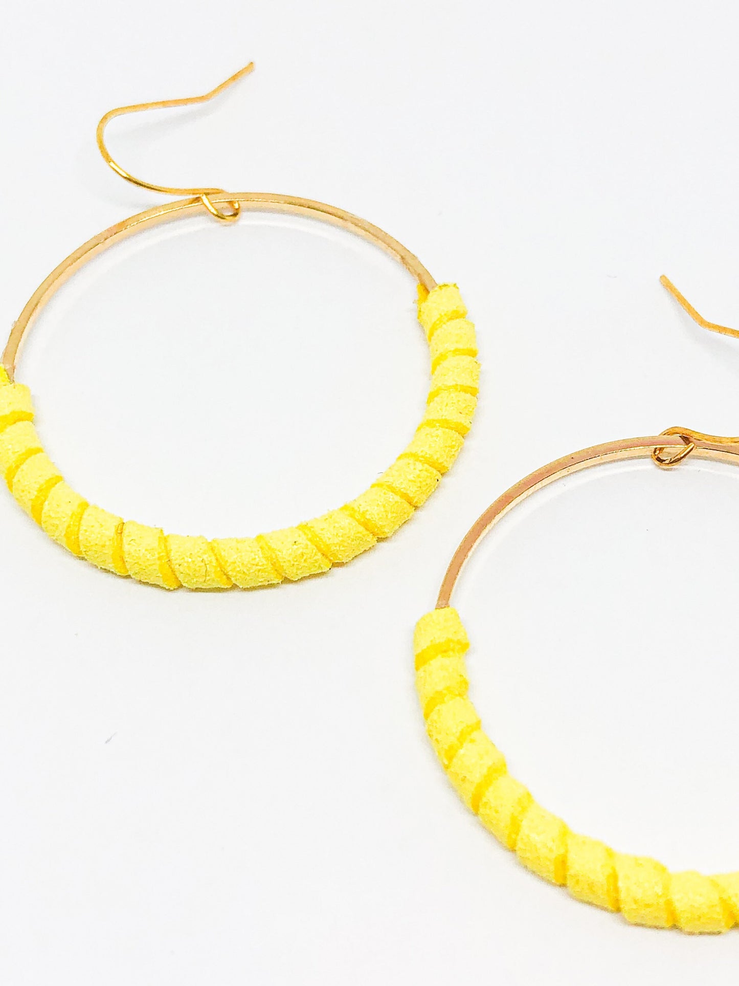 Gold hoop earrings with yellow faux suede