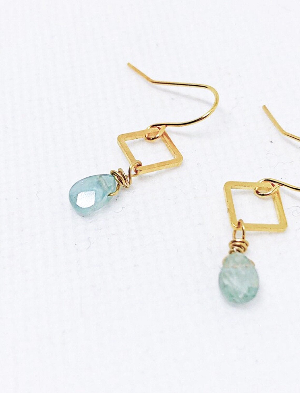 Blue aquamarine gemstone earrings with gold diamond